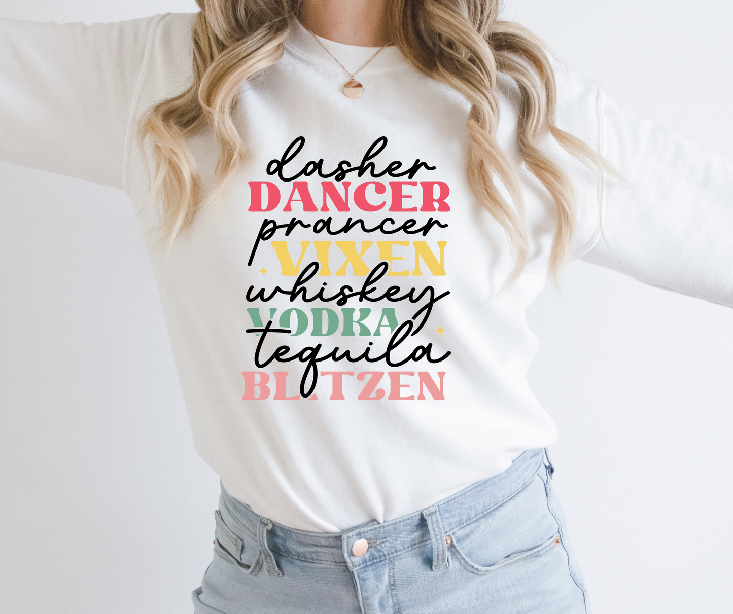 Person wearing a white sweatshirt with colorful text design on a plain background